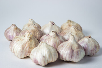 Garlic on a white background. A bunch of garlic in the middle of the frame. Agriculture concept