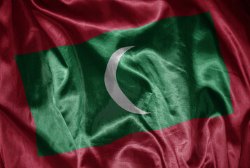 colorful shining big national flag of maldives on a silky texture