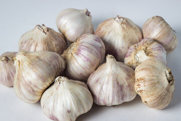 Garlic on a white background. A bunch of garlic in the middle of the frame. Agriculture concept