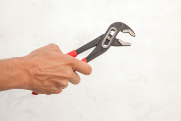 Pliers in hand and icholized on a white background. Home renovation tools.