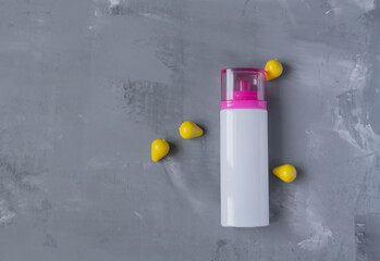 clean white bottle without inscriptions on a gray background with bright accents around