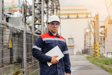 The energy engineer inspects the equipment of the substation. Power engineering. Industry