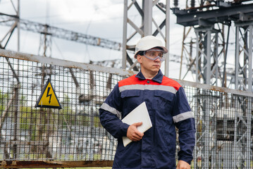 The energy engineer inspects the equipment of the substation. Power engineering. Industry