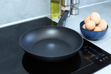 Frying pan on modern induction cooker. 