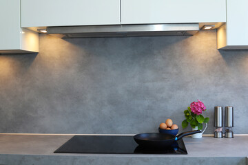 Frying pan on modern induction cooker. 