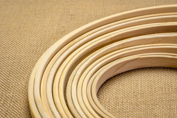 set of bamboo embroidery hoops against burlap canvas, craft and hobby concept