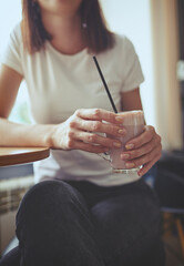 Woman drink pink matcha latte with milk in cafe.Relaxation mood.Blurred image,selective focus
