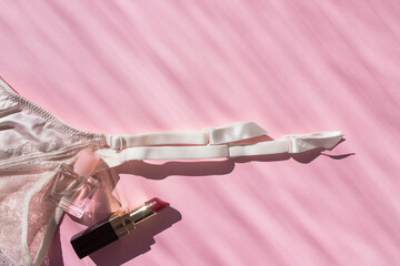 Naklejka premium Lingerie garter for stockings on pink background