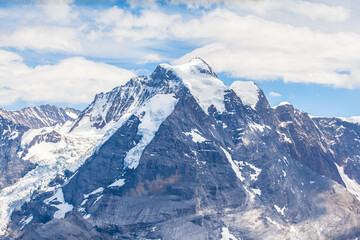 Fototapeta na wymiar Stunning view of Jungfrau from Schilthorn peak of Swiss Alps on Bernes Oberland, Switzerland