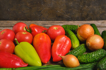 Fototapeta na wymiar Fresh vegetables, tomatoes,cucumbers, bell peppers and onions.