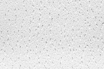 Plaster or cast material. Close up of a white background or texture. Irregular surface with grey and black pores.