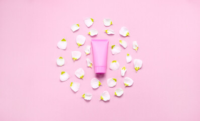 Delicate skin care cosmetic feminine flatlay. Top view Creative composition of face cream ,glass bottles and jars with cosmetic and flowers leaves