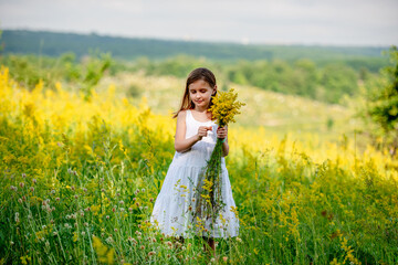 Cute little girl holding wildflower bouquet