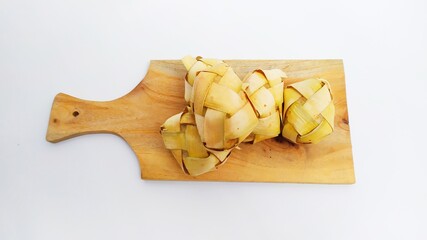 Kupat or ketupat Indonesian traditional food with rice ingredients wrapped with palm leaves isolated on white background