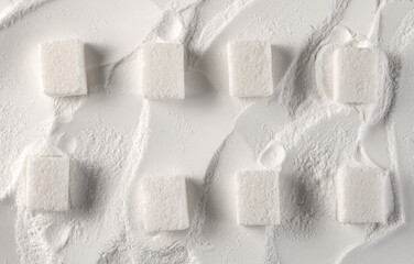 White sugar powder and cubes background and texture, top view