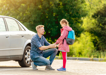 Father meeting little girl after classes