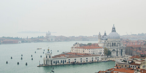 Panorama view from San Marco campanile on Venice Grand Canal, Basilica di Santa Maria della Salute in cloudy weather, Italy