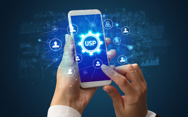 Female hand holding smartphone with USP abbreviation, modern technology concept