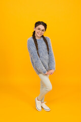 she is an optician. Portrait of happy girl in glasses. cute smiling girl with fashionable hairstyle. smart looking kid yellow background. Positive emotions. kid wear glasses because of poor eyesight