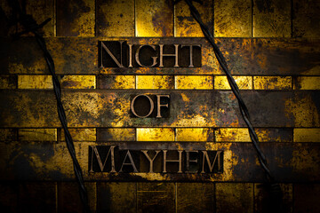 Night of Mayhem text formed with real authentic typeset letters on vintage textured silver grunge...