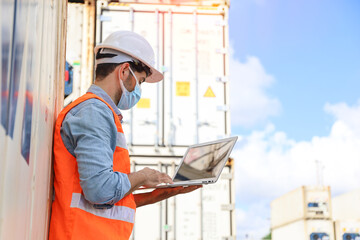 A engineering working at container stock yard, radio mobile talking communication with loader forklift for transport control handling