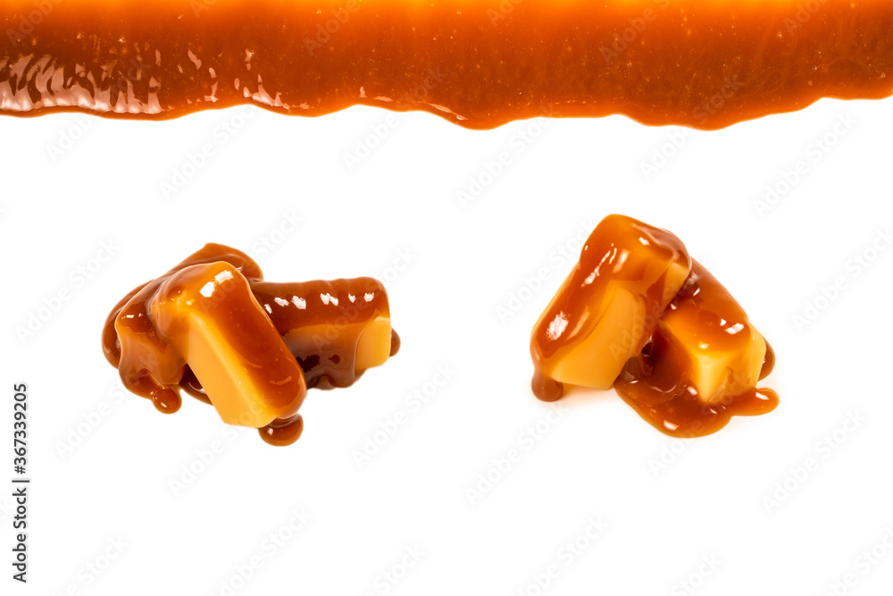Wall mural Background of flowing caramel sauce isolated on white. - Wall murals