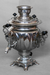 Samovar for tea metal on a gray background