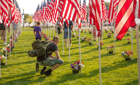 Salem, Oregon;  An army veteran remembering his fellow soldiers in a fourth of July fag memorial in Riverfront park in Salem