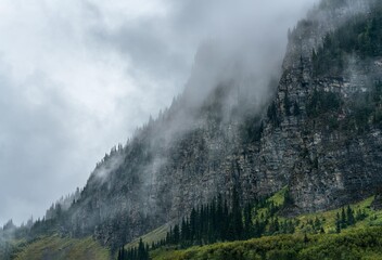 The clouds roll through the mountains on a rainy day in Glacier National Park, Montana, USA