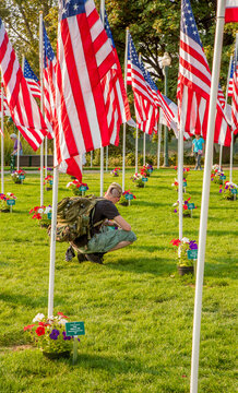 Salem, Oregon;  An army veteran remembering his fellow soldiers in a fourth of July fag memorial in Riverfront park in Salem