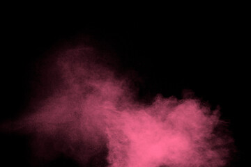 Pink dust particles splash on black background.Pink powder splash.