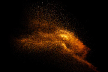 Abstract motion blurred brown sand background.Sandy explosion isolated on over dark background.