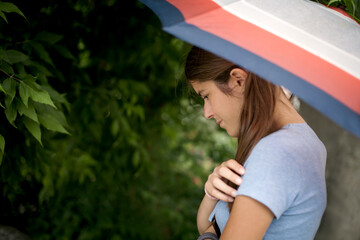  sad girl under an umbrella