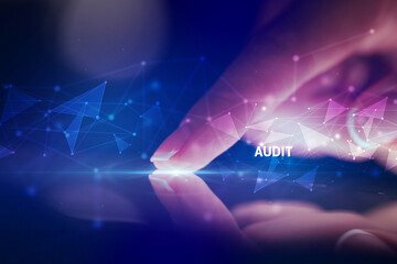 Finger touching tablet with AUDIT inscription, business concept