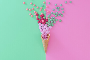 Flat lay style sweet treat food concept photo using complementary colours palette of pink and green.  Candy colours reversed against background.  Copy space available