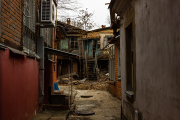 The cluttered old courtyard of an old house built before the revolution in Russia.