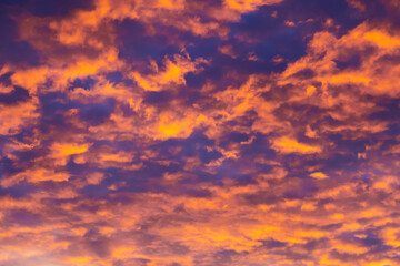 Blazing sky, dramatic sunset. Sky is like a conflagration, majestic atmosphere. Clouds at sunset illuminated by the sun from below