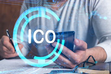 Multiexposure of man signing contract with phone and ico hologram. Concept of initial coin...