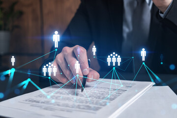 Businessman in suit signs contract. Double exposure with social network hologram. Man signing...