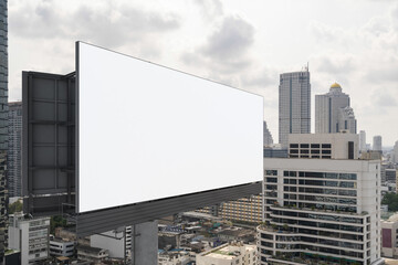 Blank white road billboard with Bangkok cityscape background at day time. Street advertising poster, mock up, 3D rendering. Side view. The concept of marketing communication to promote or sell idea.