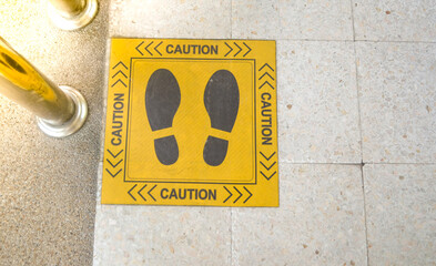 Foot symbol sticker for social and physical distanceing in super market during covid-19 pandemic.social distancing at hospital.