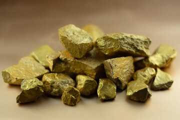 Group fo gold nugget at the golden background