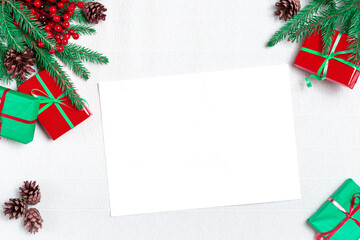 Fototapeta na wymiar Mockup Christmas greeting card top view, flatlay on a white paper background , space for your text