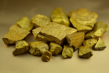 Group fo gold nugget at the golden background