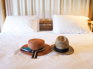 Vintage straw hat, fashion of tourist on the bed