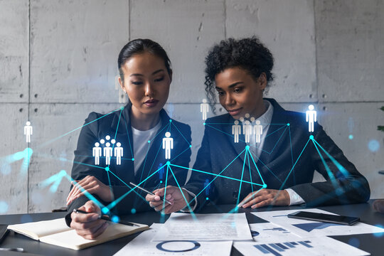 Two businesswomen work together in modern office on new project. Double exposure. Concept of success. Social network theme drawing.