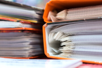 File document orange binders for accountant audit in bookkeeping business office. Archive auditing...