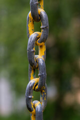 An old metal chain on a blurred background.