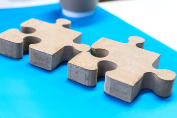 jigsaw puzzle pieces for teamwork on blue paper background, teamwork put pieces together to connect cooperation. Business team work solutions in success or strategy concept