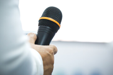 Teacher hold microphone for teacching on speech or speaker at seminar conference and speaking with...